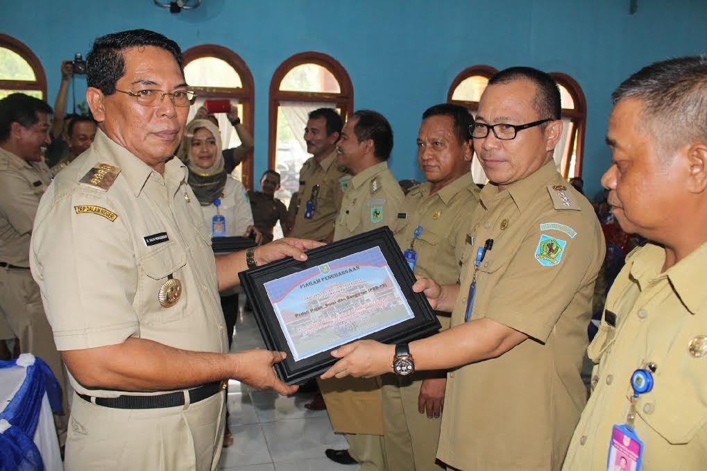 Bupati Bolmong Hi Salihi Mokodongan dalam acara Lauching menyerahkan simbolis dokumen SPPT PBB-P2 -DHKP kepada perangkat pemerintah kecamatan dan desa